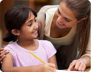 An educator helping a student with schoolwork
